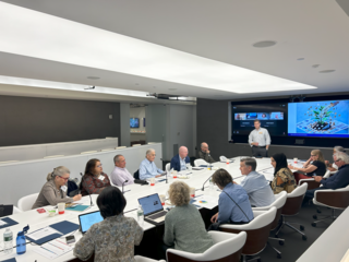 Board members sitting around a table at a meeting. 